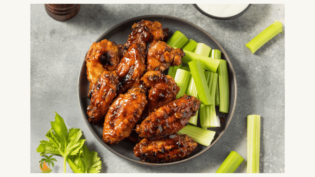 Crispy chicken wings being glazed in a wok - technique learned in Bangkok