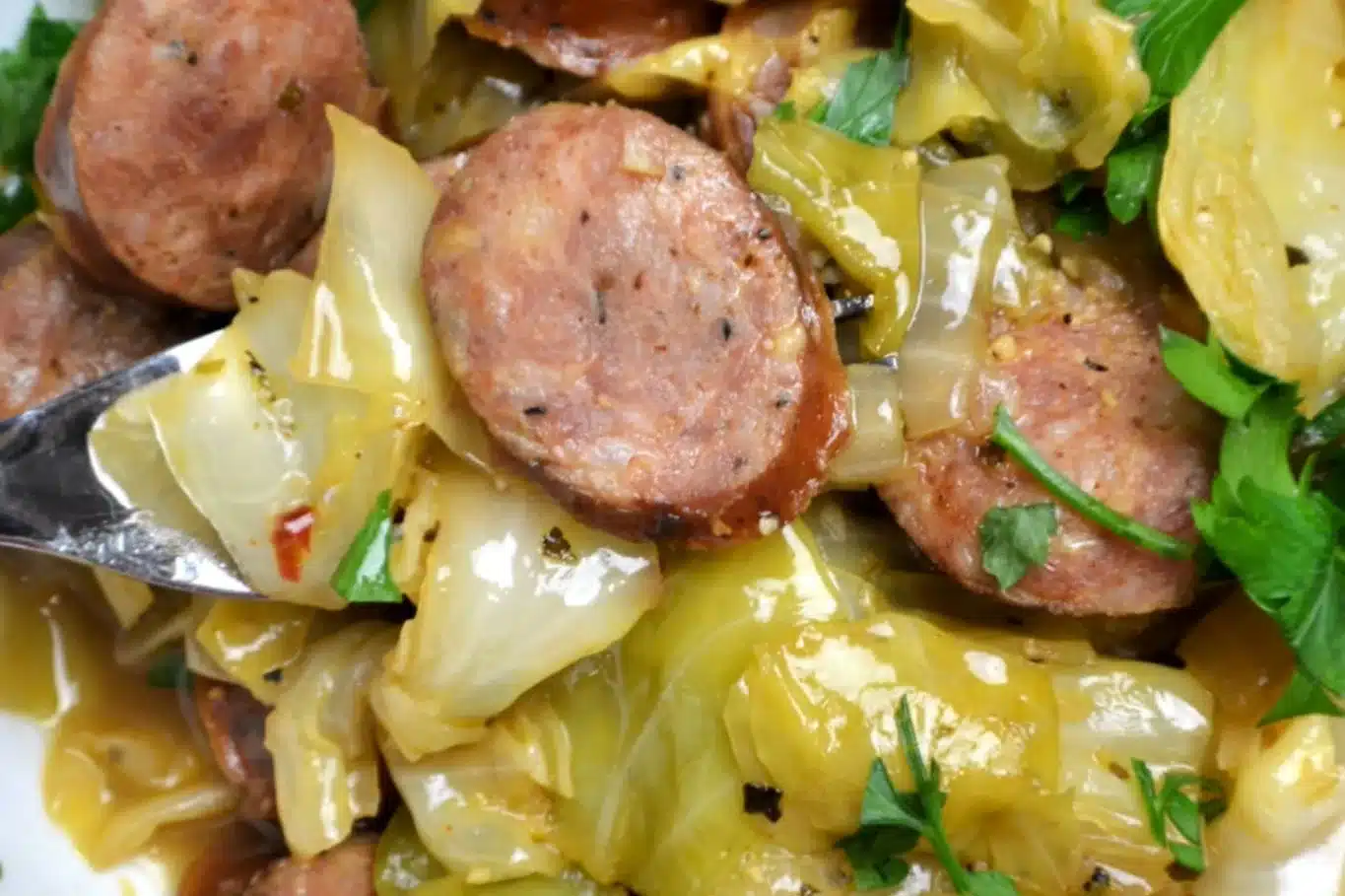 Delicious Chicken Sausage and Cabbage dish with sautéed onions, garlic, and spices, garnished with fresh parsley for a flavorful and healthy meal.