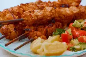 Chicken Shish Tawook Recipe 5 Delicious Chicken Shish Tawook skewers grilled to perfection, served with fresh cucumber and tomato salad and lemon wedges. A flavorful Middle Eastern dish perfect for barbecues and family dinners.