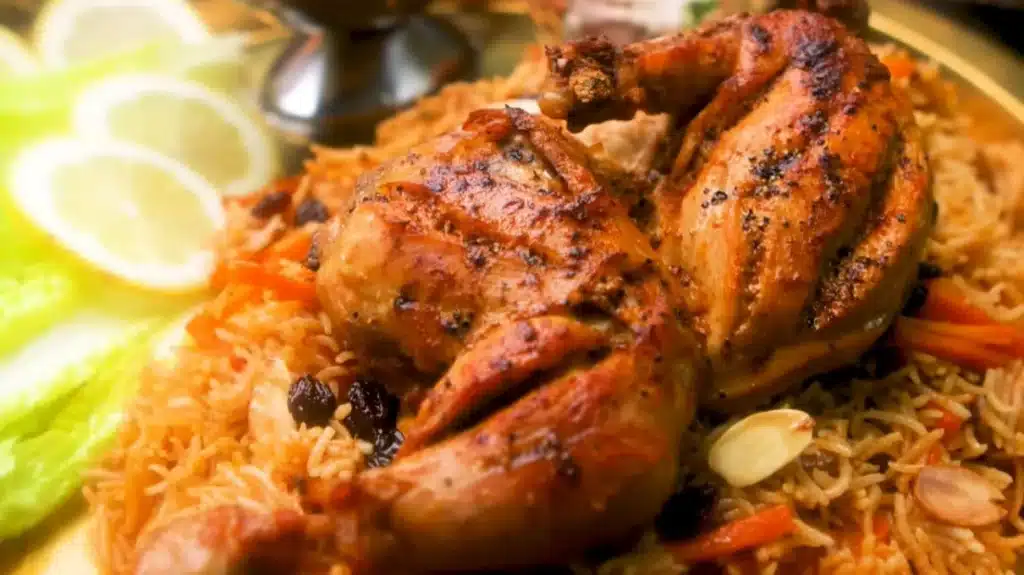 Chicken Kabsa Rice recipe with spiced grilled chicken aromatic basmati rice raisins almonds and carrots – a flavorful Middle Eastern dish