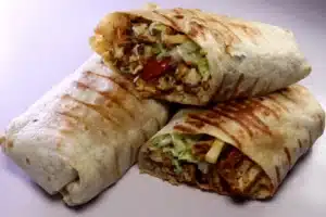 Authentic Lebanese Chicken Shawarma Recipe – Easy & Delicious 4 Delicious Lebanese Chicken Shawarma wrap with grilled, marinated chicken, fresh vegetables, and flavorful sauces, served in a warm pita or flatbread.
