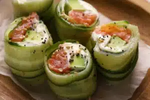 Easy Smoked Salmon Roulade on Cucumber Chatelaine 6 Smoked Salmon Roulade on Cucumber Chatelaine a gourmet appetizer featuring thinly sliced cucumber wrapped around smoked salmon, cream cheese, and avocado, topped with seasoning for a fresh and elegant presentation