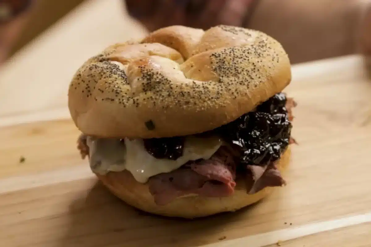 How to Make the Perfect Knob Sandwich with poppy seed bagel, roast beef, melted cheese, and sweet chutney. A delicious sandwich recipe for a perfect meal.