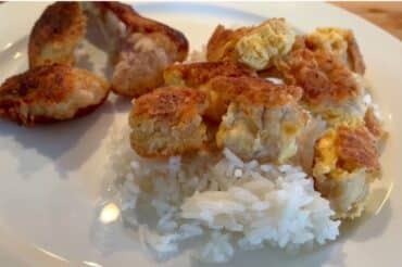 Crispy fried California Corbina recipe served over steamed white rice on a white plate, showcasing a flavorful homemade seafood dish.