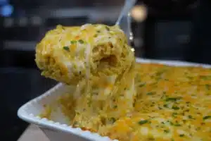 Mamaw’s Chicken and Rice Casserole – Creamy Southern Classic 2 Mamaw's Chicken and Rice Casserole topped with melted cheddar cheese, served hot in a white baking dish.