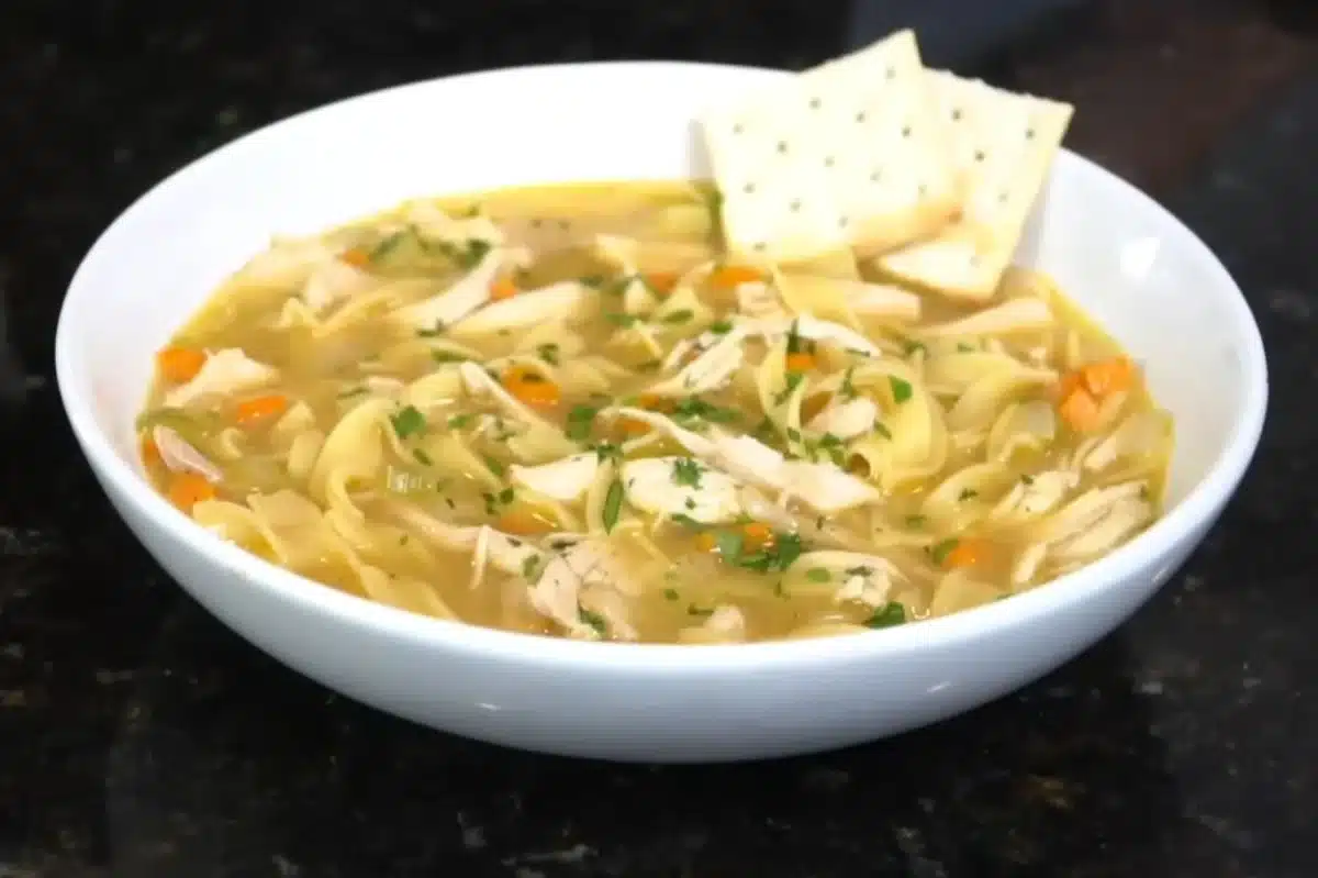Home 1 Featured image for an article about the benefits of Accent seasoning, showing a delicious bowl of spicy chicken noodle soup.