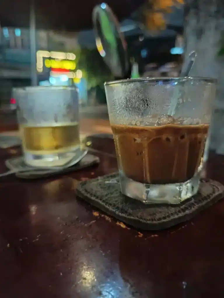 Ca Phe Sua Da being stirred by hand with a spoon