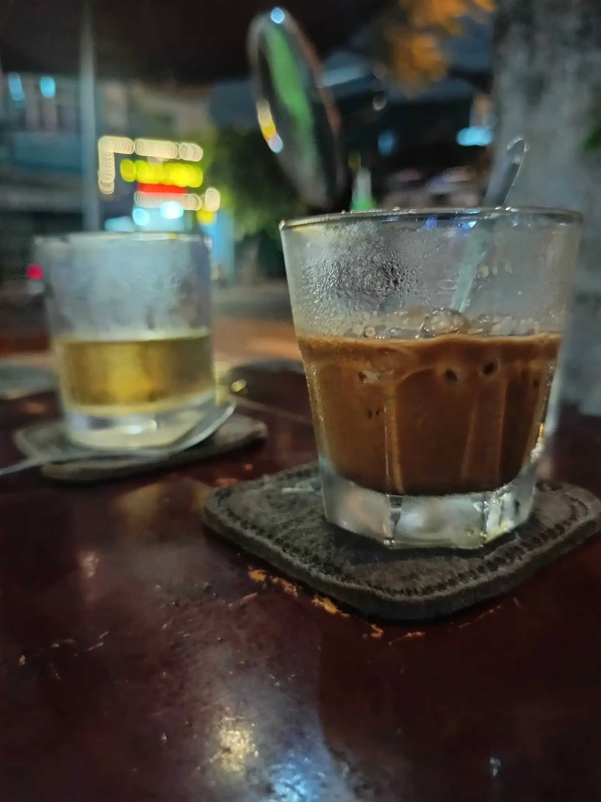 Ca Phe Sua Da being stirred by hand with a spoon