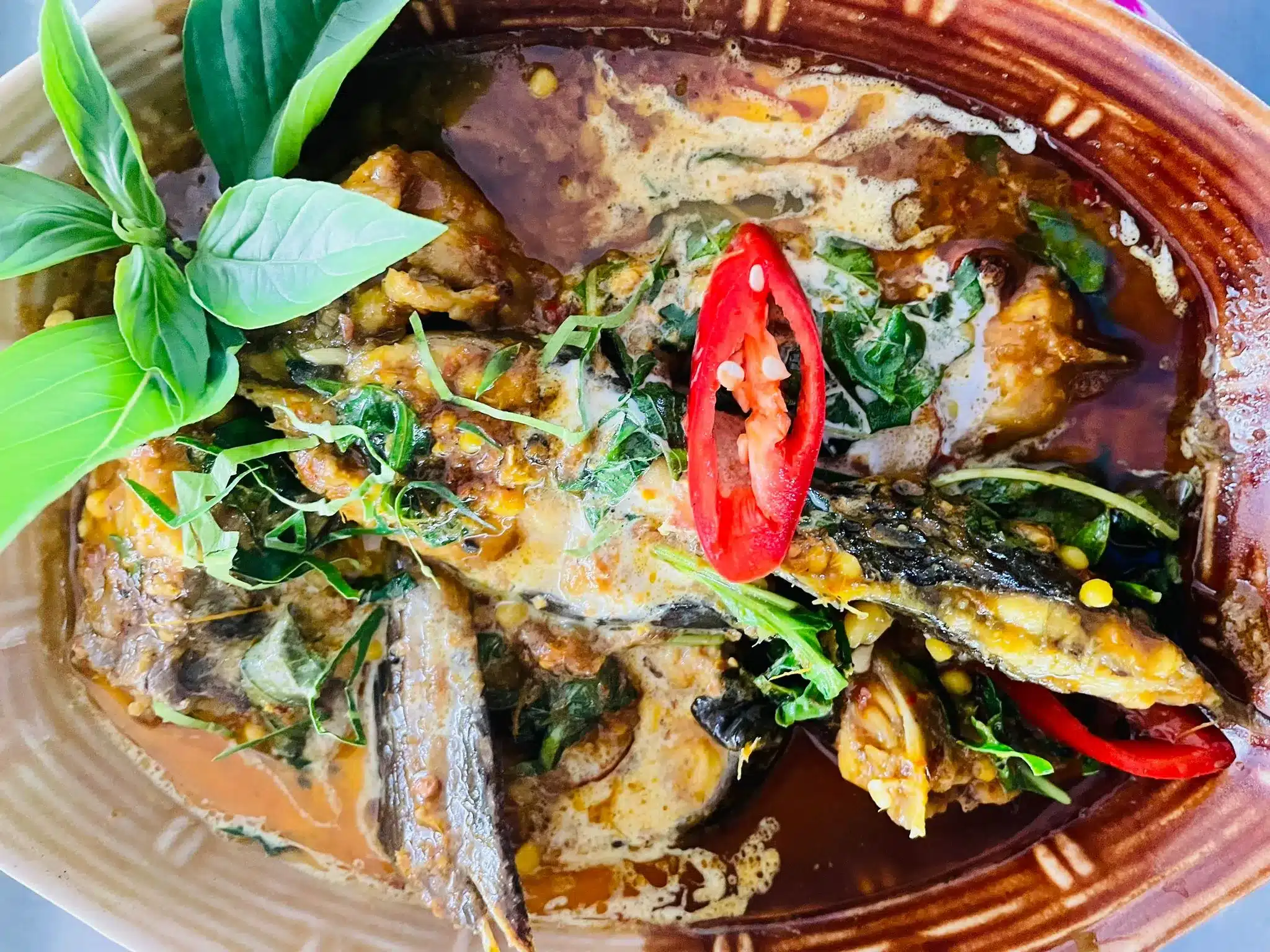 A Thai curried fish dish with fresh herbs.