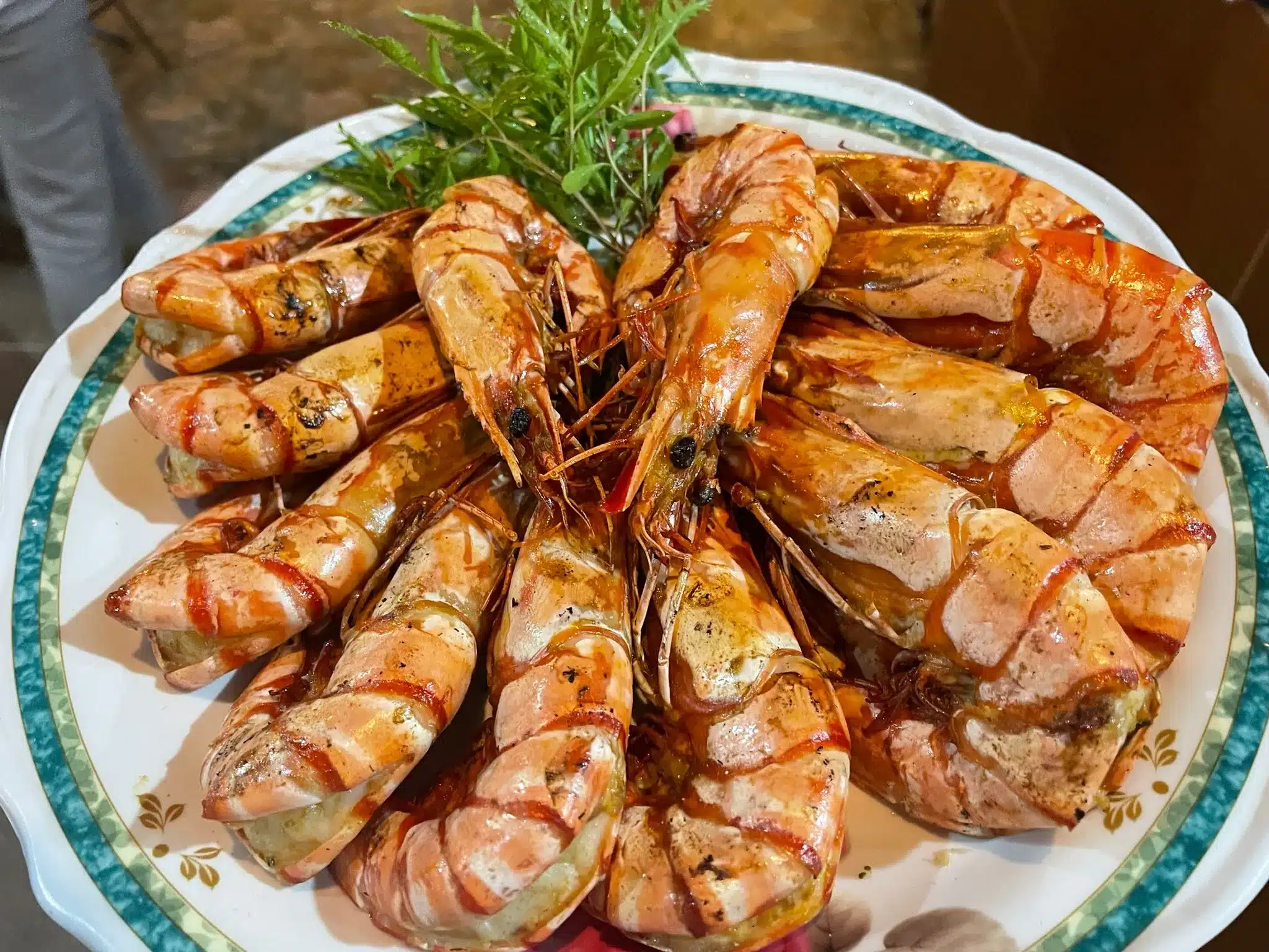 A plate of perfectly cooked king prawns, ready to eat.