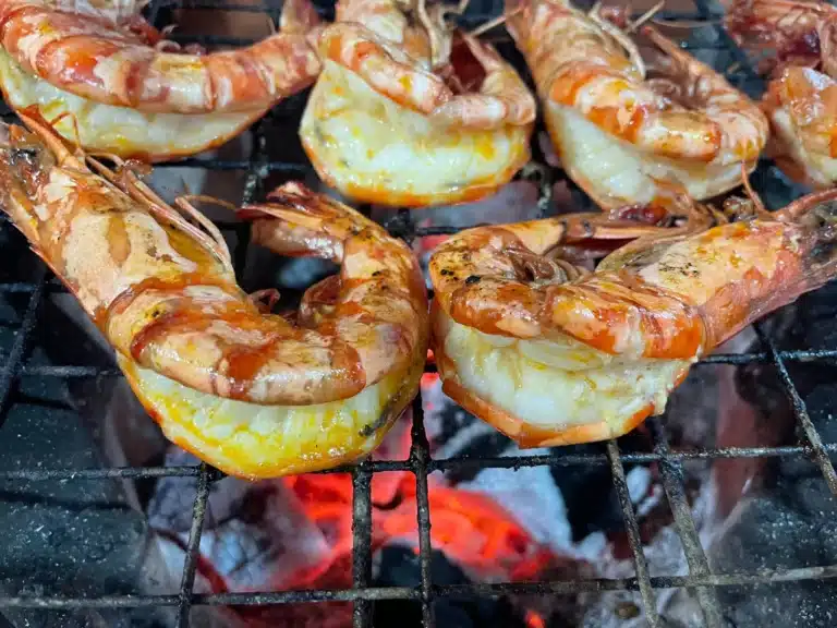 Prawns cooking on carcoal BBQ Bangkok