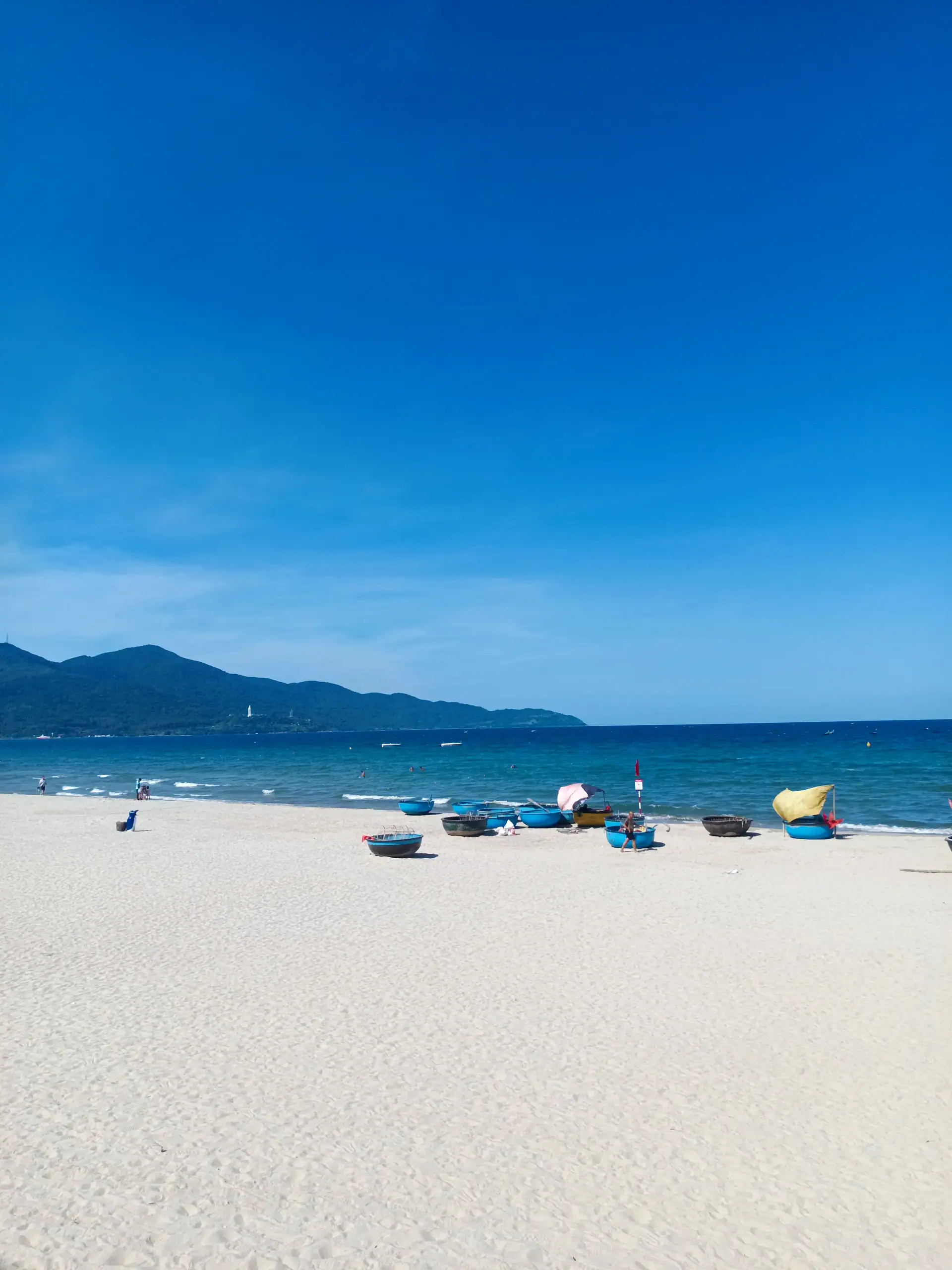Discover Da Nang in 2025: The Most Comprehensive Travel Guide to Vietnam’s Coastal Gem 2 My Khe Beach with traditional Vietnamese fishing boats under a sunny sky, Da Nang, Vietnam