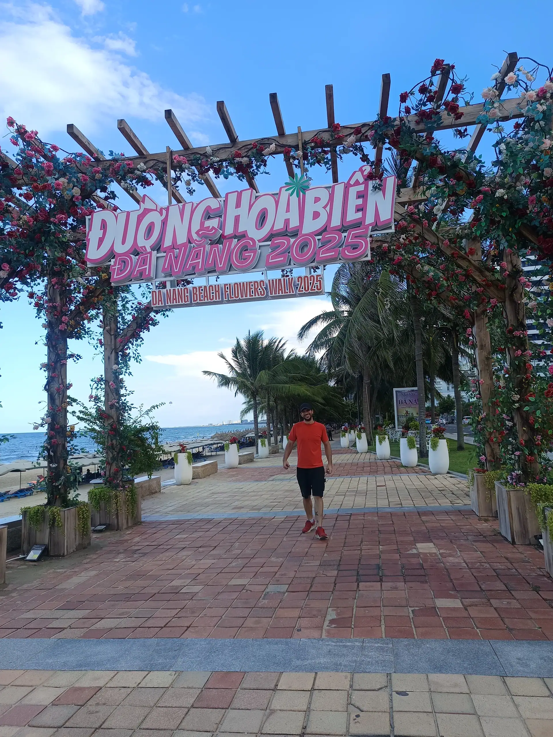 Discover Da Nang in 2025: The Most Comprehensive Travel Guide to Vietnam’s Coastal Gem 4 Oliver walking under a sign at Duong Hoa Bien 2024, beachfront, Da Nang, Vietnam