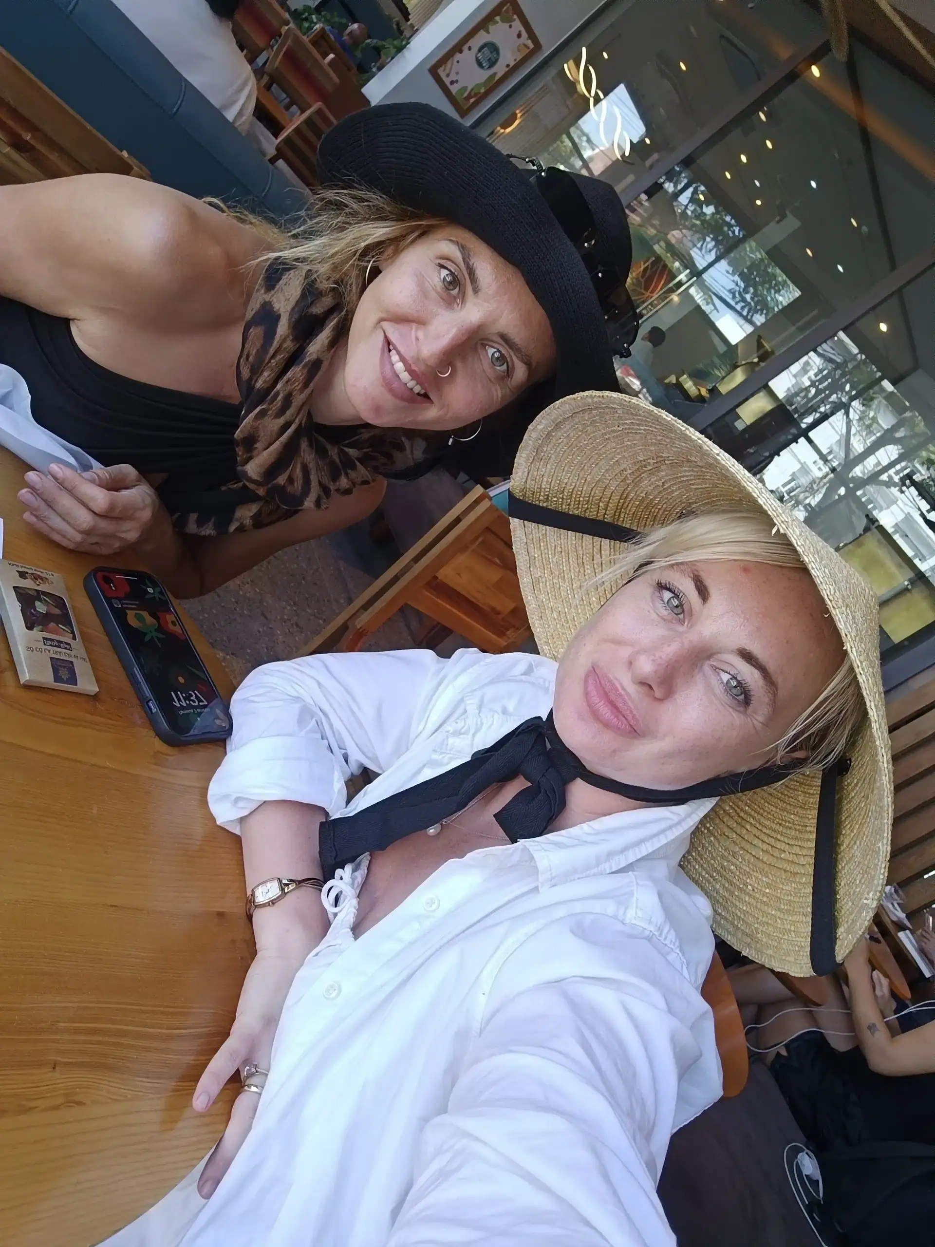 Discover Da Nang in 2025: The Most Comprehensive Travel Guide to Vietnam’s Coastal Gem 1 Bright tropical cafe scene with women wearing sun hats, showcasing relaxed island vibes and outdoor dining.