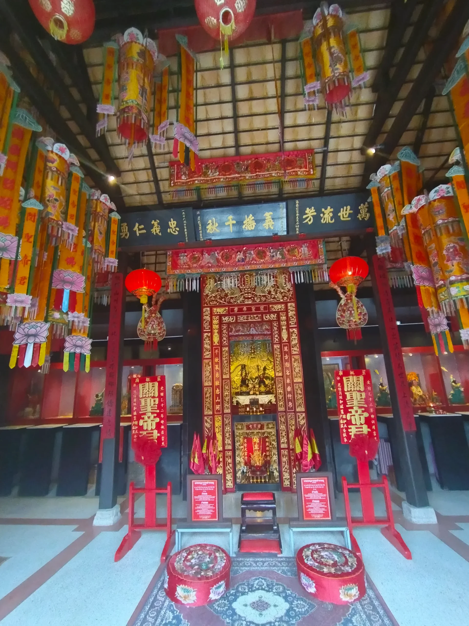 Guan Yu Koh Samui Shrine: Hua Thanon Red Temple Guide 4 Interior of the Guan Yu shrine main hall with red lanterns, gold altar, and prayer cushions, Hua Thanon, Koh Samui