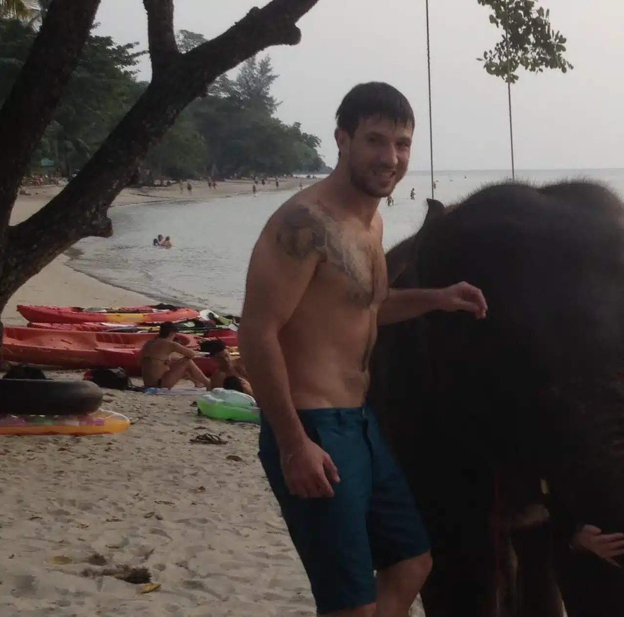 Oliver and baby elephant swimming in the sea together—archival family photo from 20+ years ago