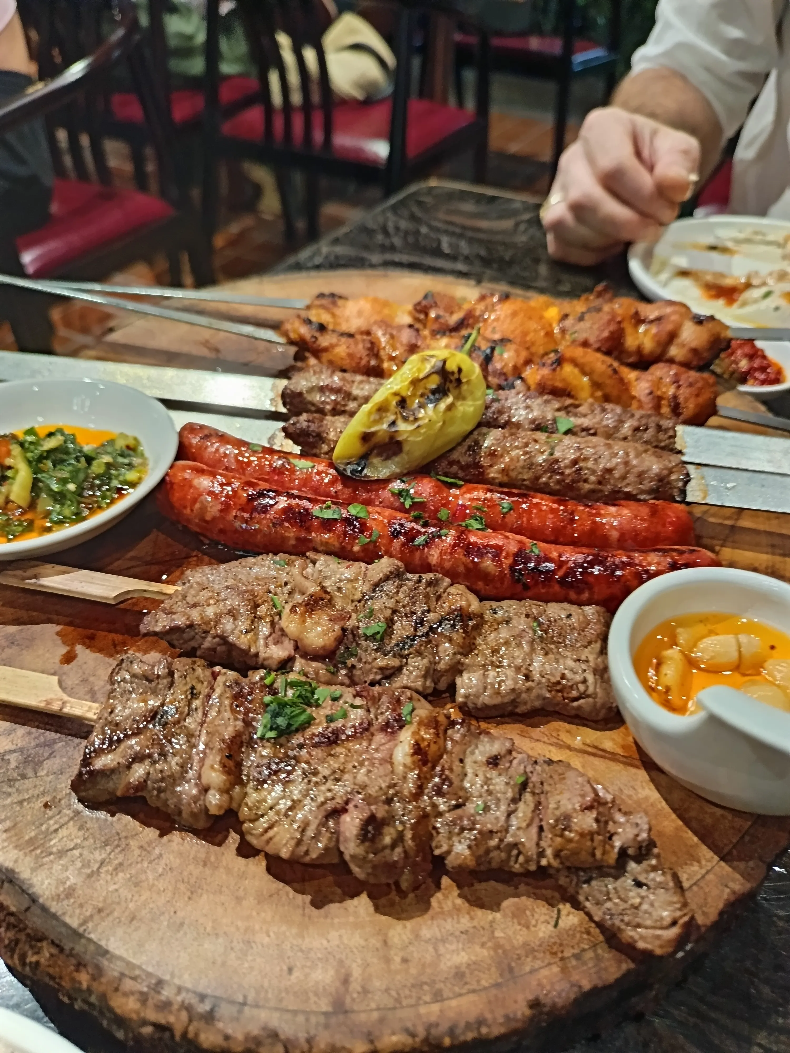 Authentic Shish Tawook and meat kebabs at Ogen Hua Hin, Thailand, demonstrating professional Middle Eastern grilling for Mangoes and Palm Trees.