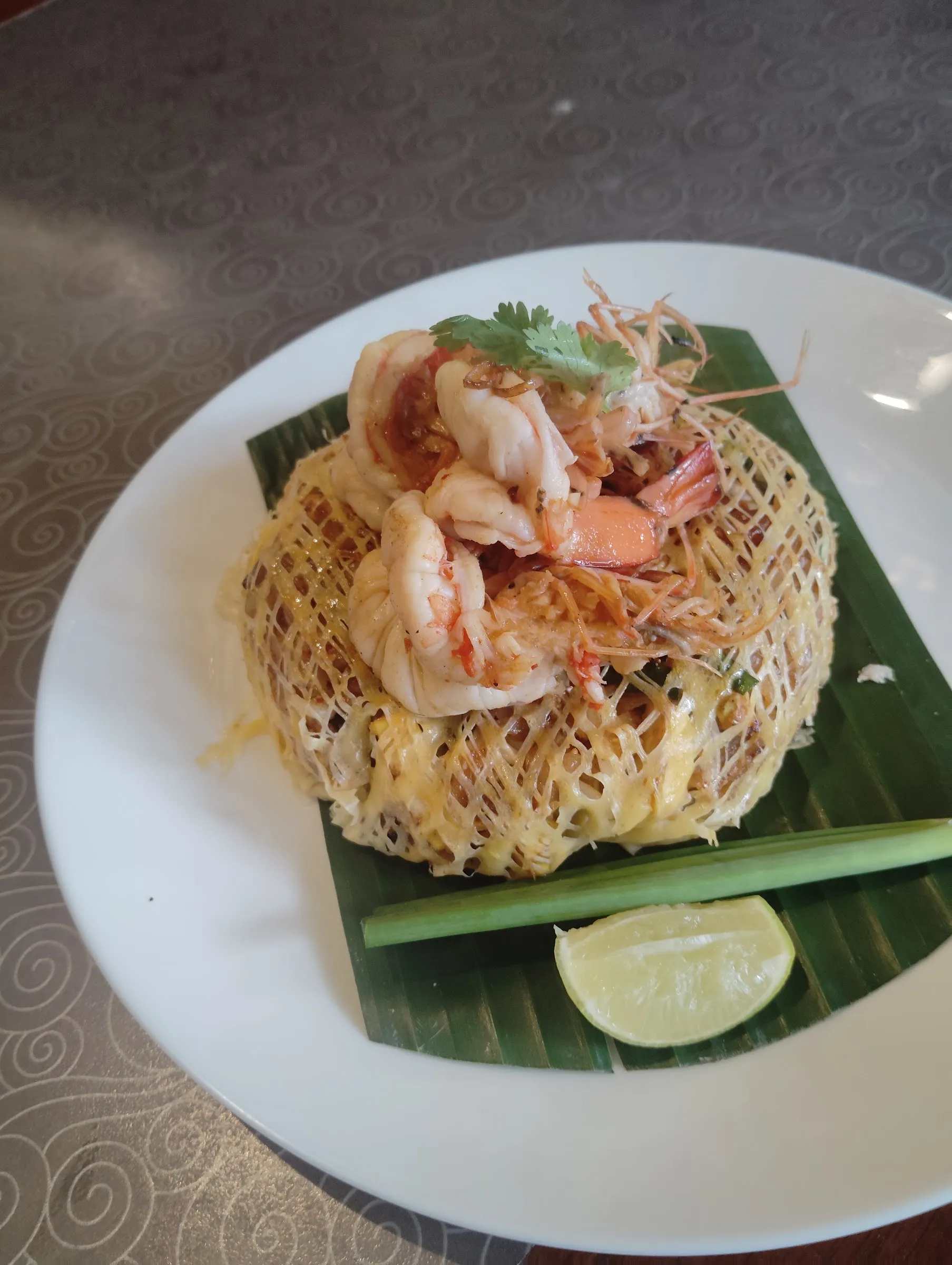 A steaming plate of authentic Pad Thai Kung (shrimp) served at a local night market.