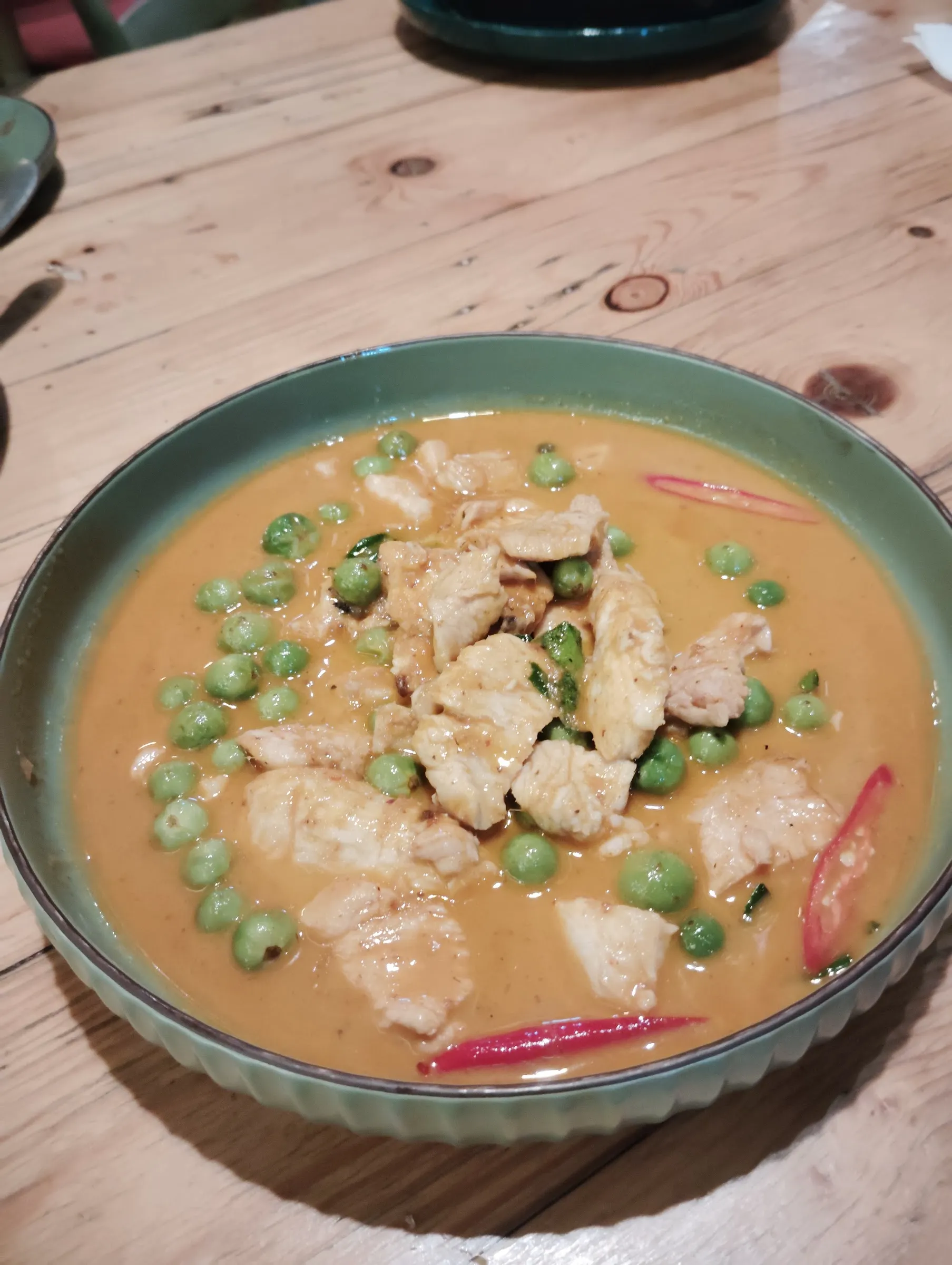 A vibrant Thai Penang Curry served in a traditional bowl, identified using AI vision tools.