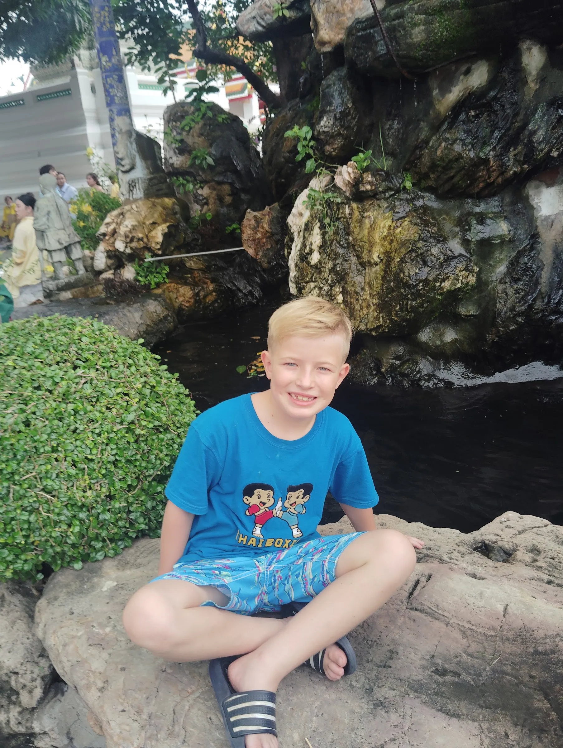 Bangkok street food guide 2026 kid-friendly travel: Victor Mayerhoffer taking a micro-break at a water feature.