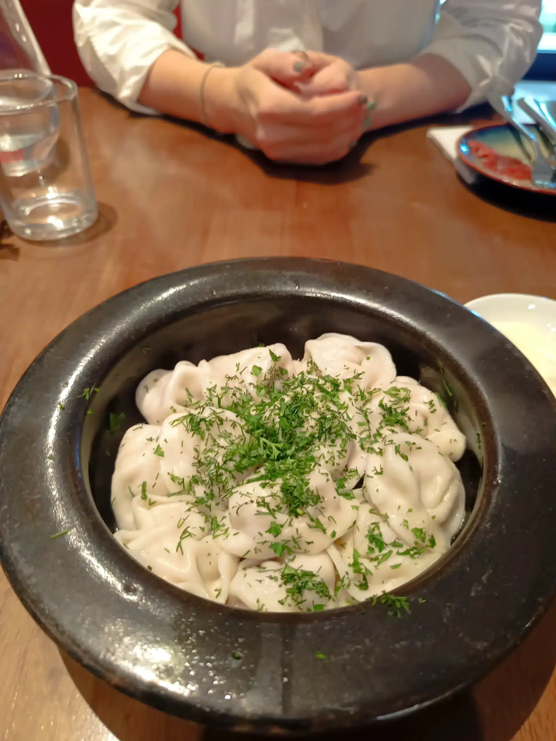 Professional review of traditional Russian pelmeni served in a ceramic bowl at Vinegrette Kitchen Da Nang, 2026.