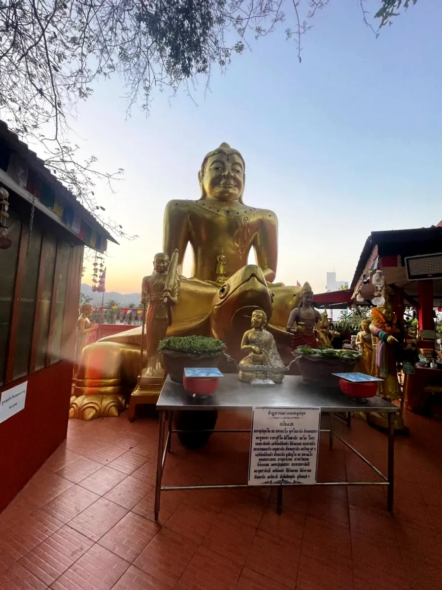 The big golden sitting Buddha shrine inside Wat Tham Khao Tao cliffside cave