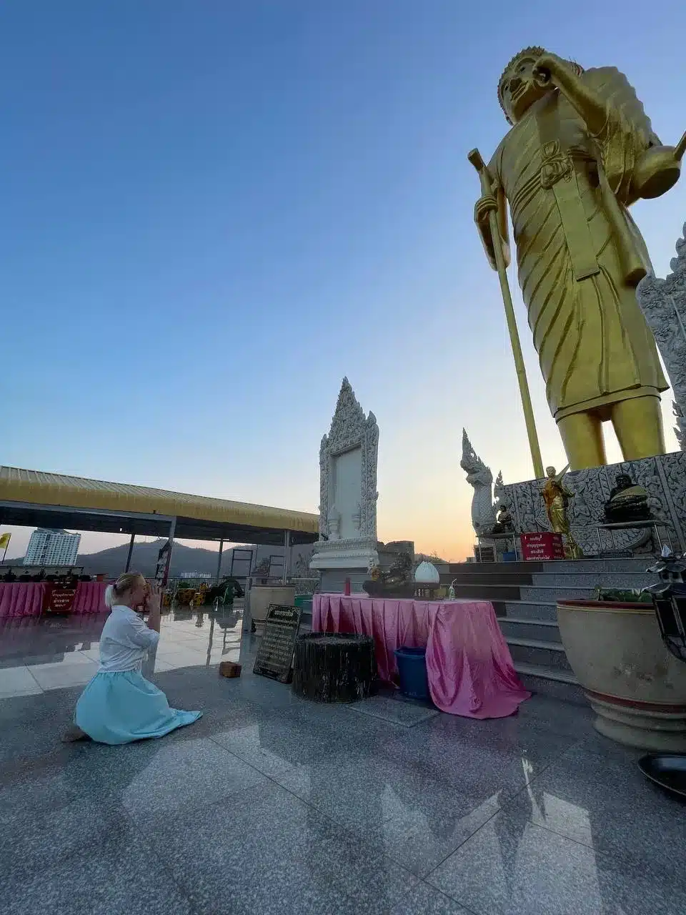 Natalia Mayerhoffer kneeling in front of the big standing Buddha at Wat Khao Noi Hua Hin landmarks fieldwork April 2026