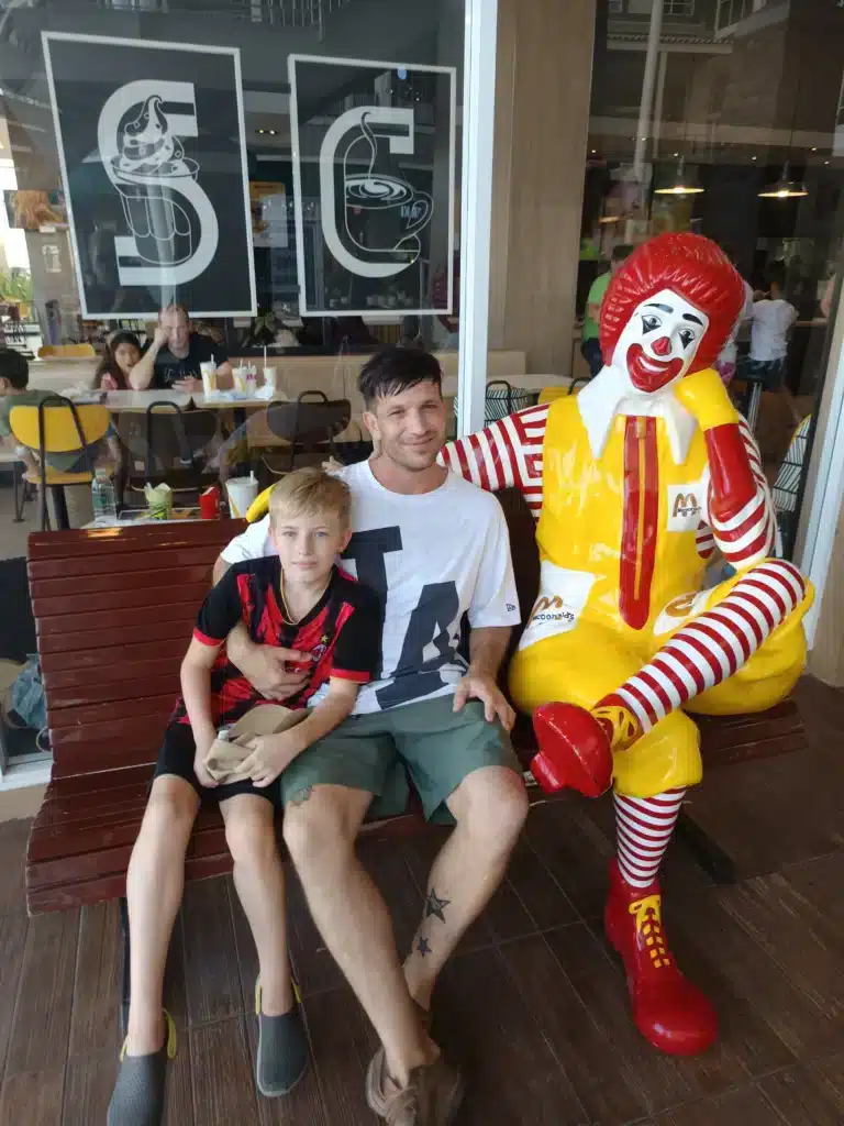 Oliver & Victor Mayerhoffer sat outside mcdonalds in Market villiage thailand, hua hin. Sat with Ronald mcdonald staue
