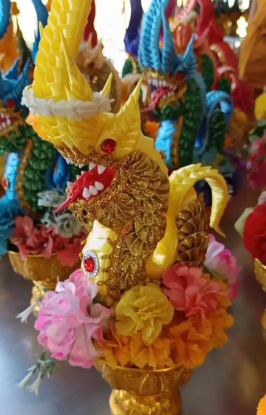 Golden paper dragon merit offerings at Wat Tham Chaeng Cha-Am
