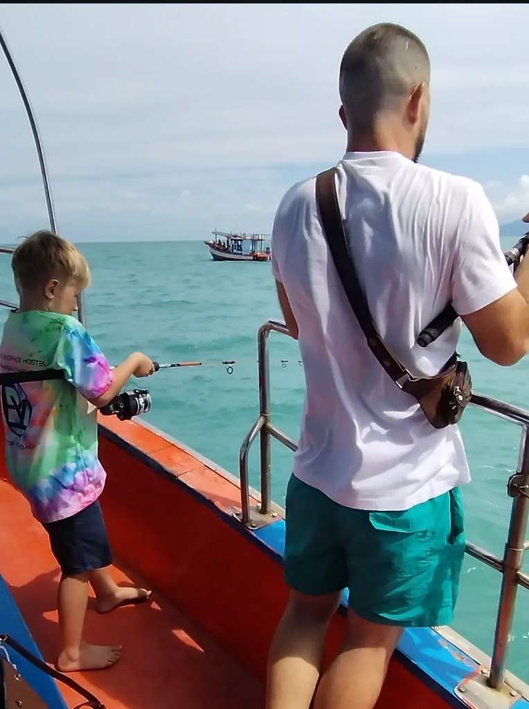 Oliver and Victor bottom fishing on a Mr. Tu wooden boat deck in the Gulf of Thailand, Koh Samui