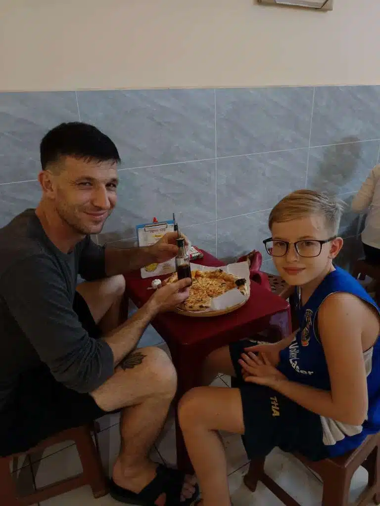 Oliver and Victor at the table during the Pizza 100 visit in Ho Chi Minh City