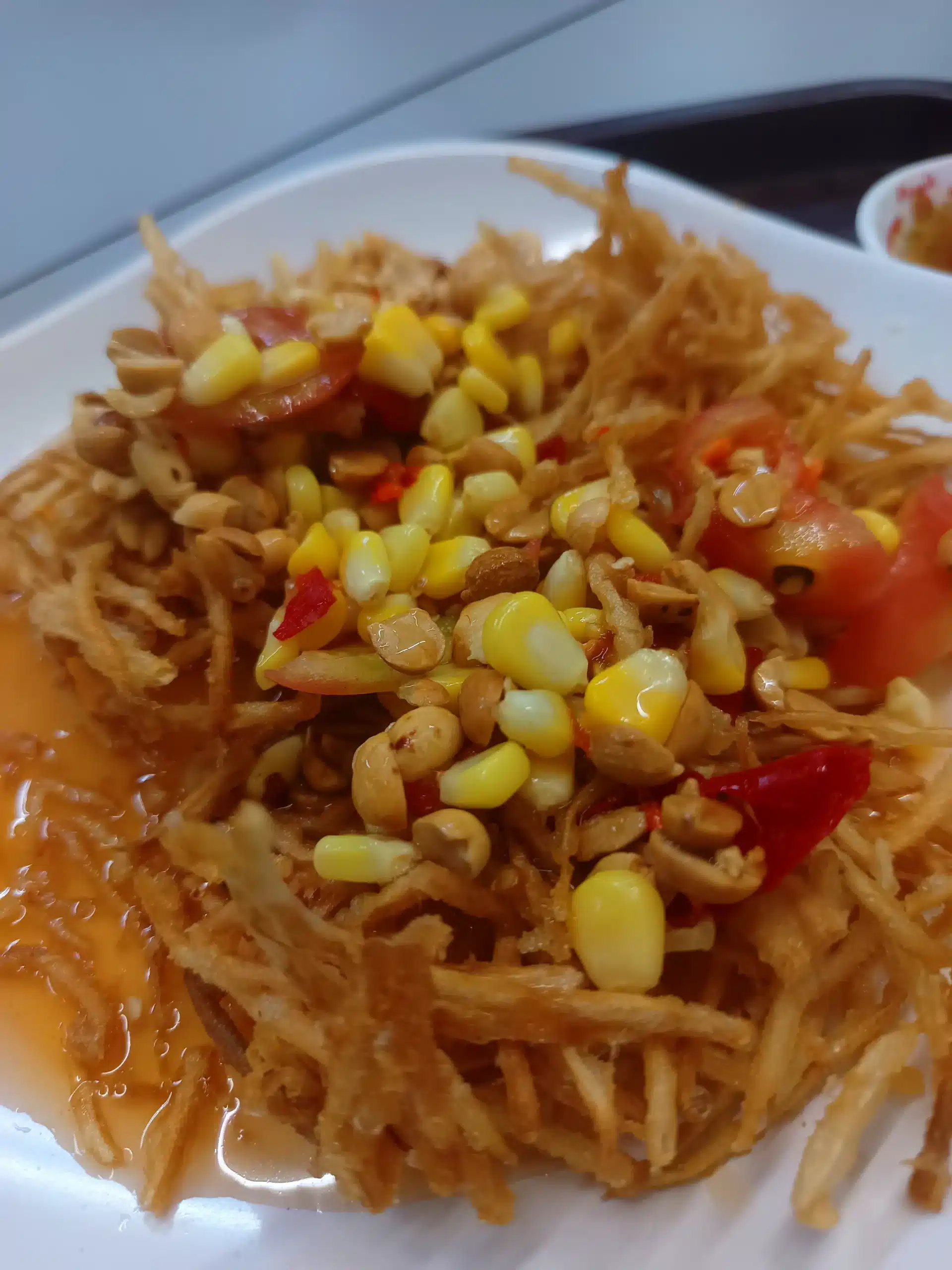 Deep-fried papaya salad mixed and ready to eat at Magic Food Point, Bangkok airport